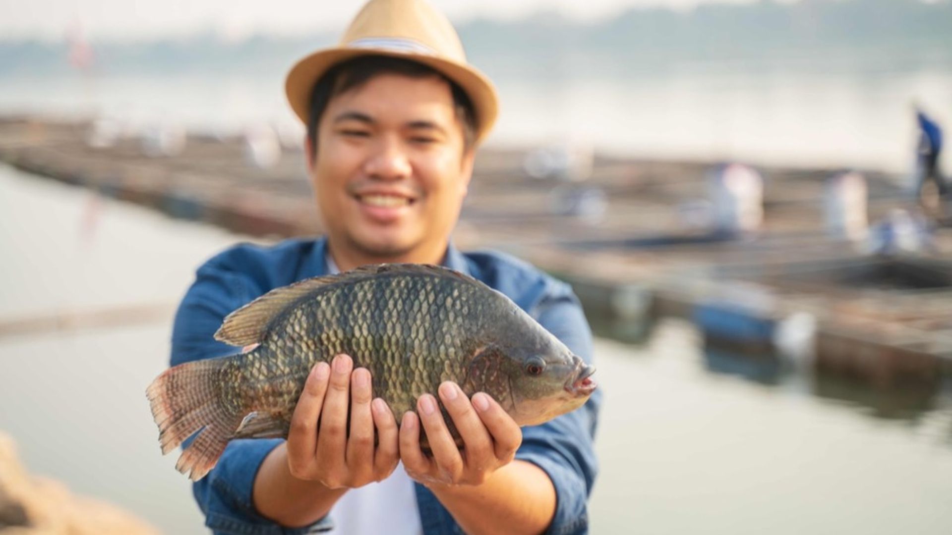 Image of an aquaculture producer holding a fish