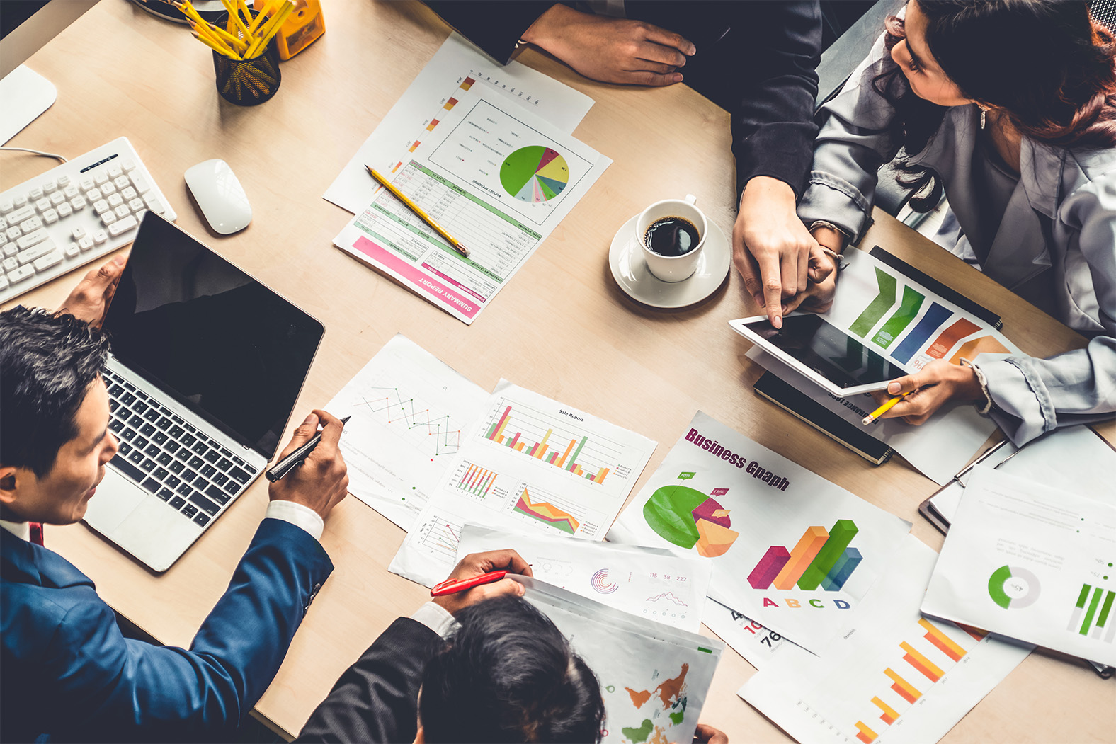 Image of a team analyzing figures during a meeting