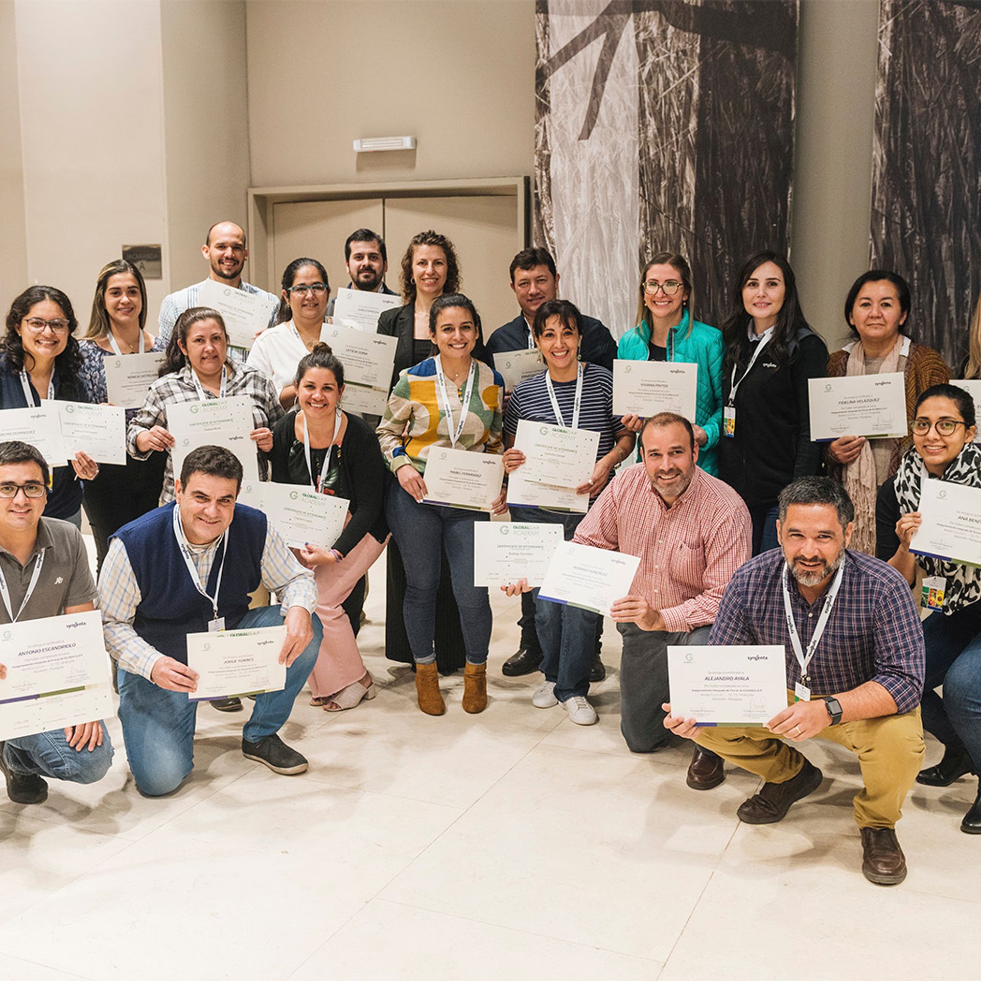 Image of participants holding certificates at the end of a private training course