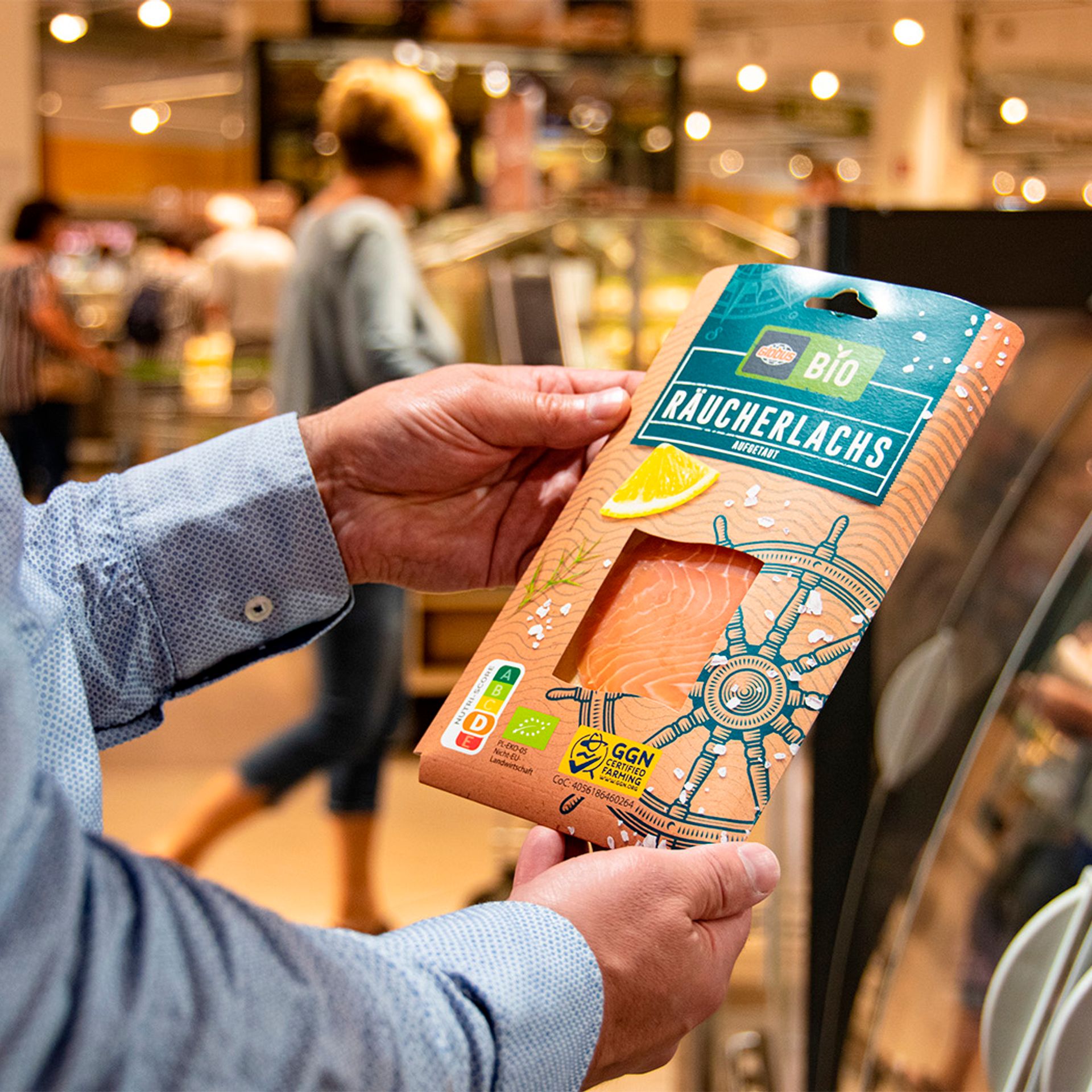 Image of a consumer holding a salmon product with the GGN label