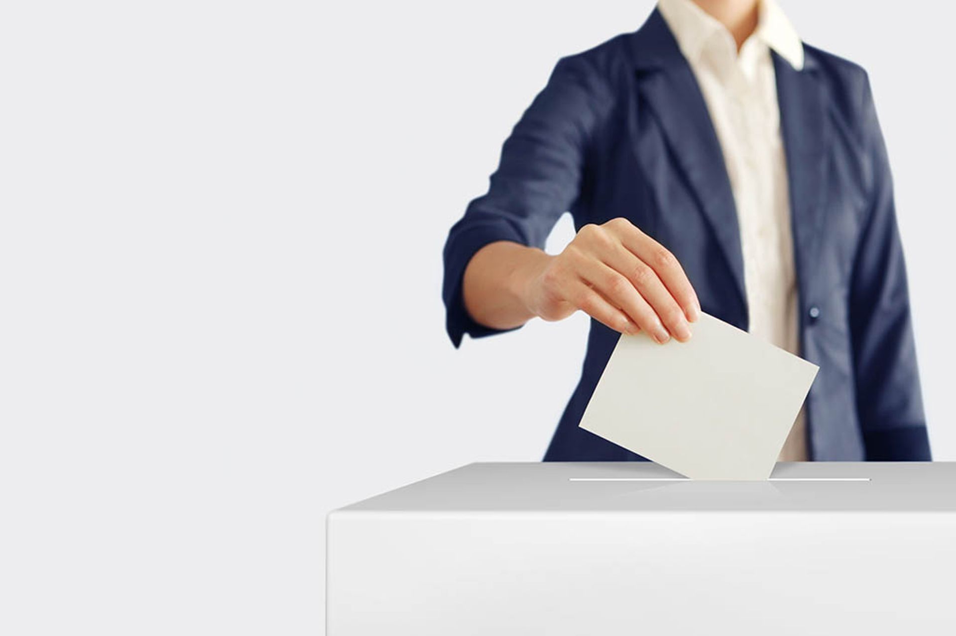 Image of a man casting a vote in a ballot box