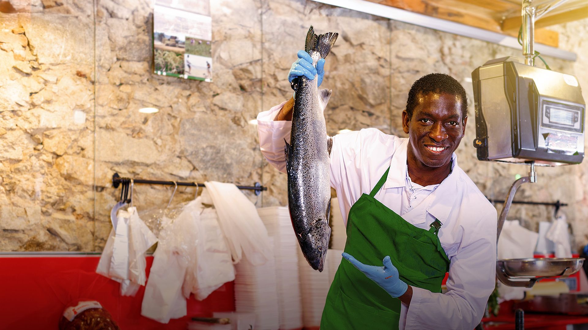 Image of a retail employee displaying fresh seafood in store 