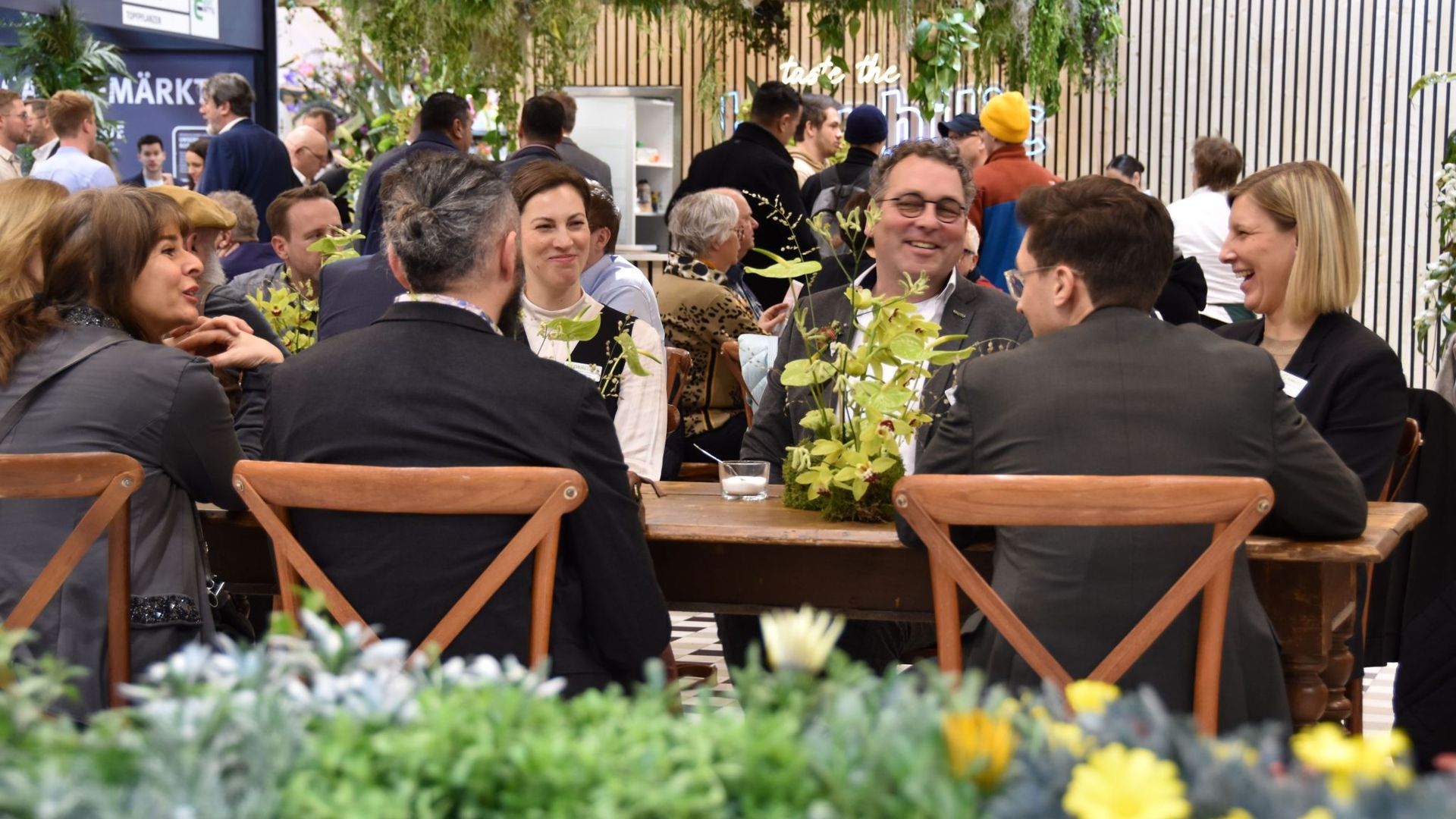 Networking and discussions take place among key stakeholders in the floriculture industry at the GLOBALG.A.P. booth at IPM 2024 trae fair in Essen, Germany. 