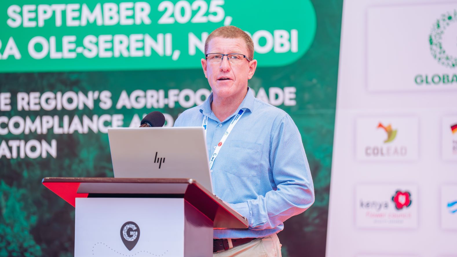 James Hart, Business Development Manager Africa at Agraya, speaks on stage at the 2025 GLOBALG.A.P. TOUR stop in Nairobi, Kenya.